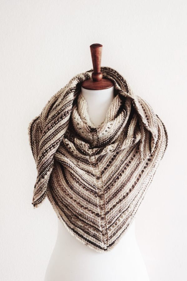Close-up of delicate eyelet lace rows in cream triangle shawl knitting pattern