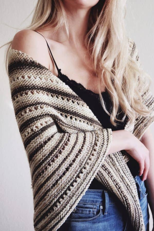 Woman wearing cream Tiramisu triangle shawl with elegant drape and lace details