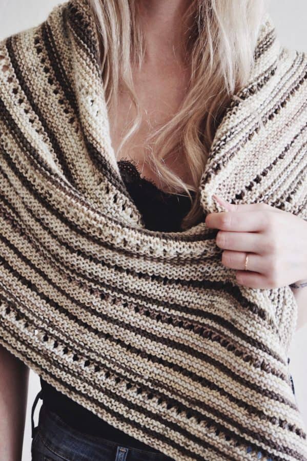 Side view of knitted triangle shawl showing classic shape and eyelet pattern detail