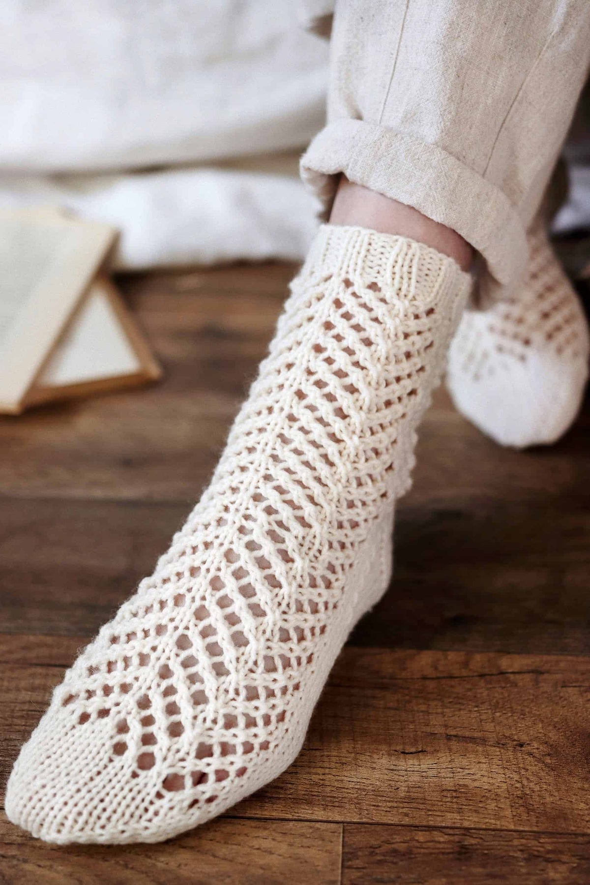 Handknit lace socks pattern with delicate arrowhead motif