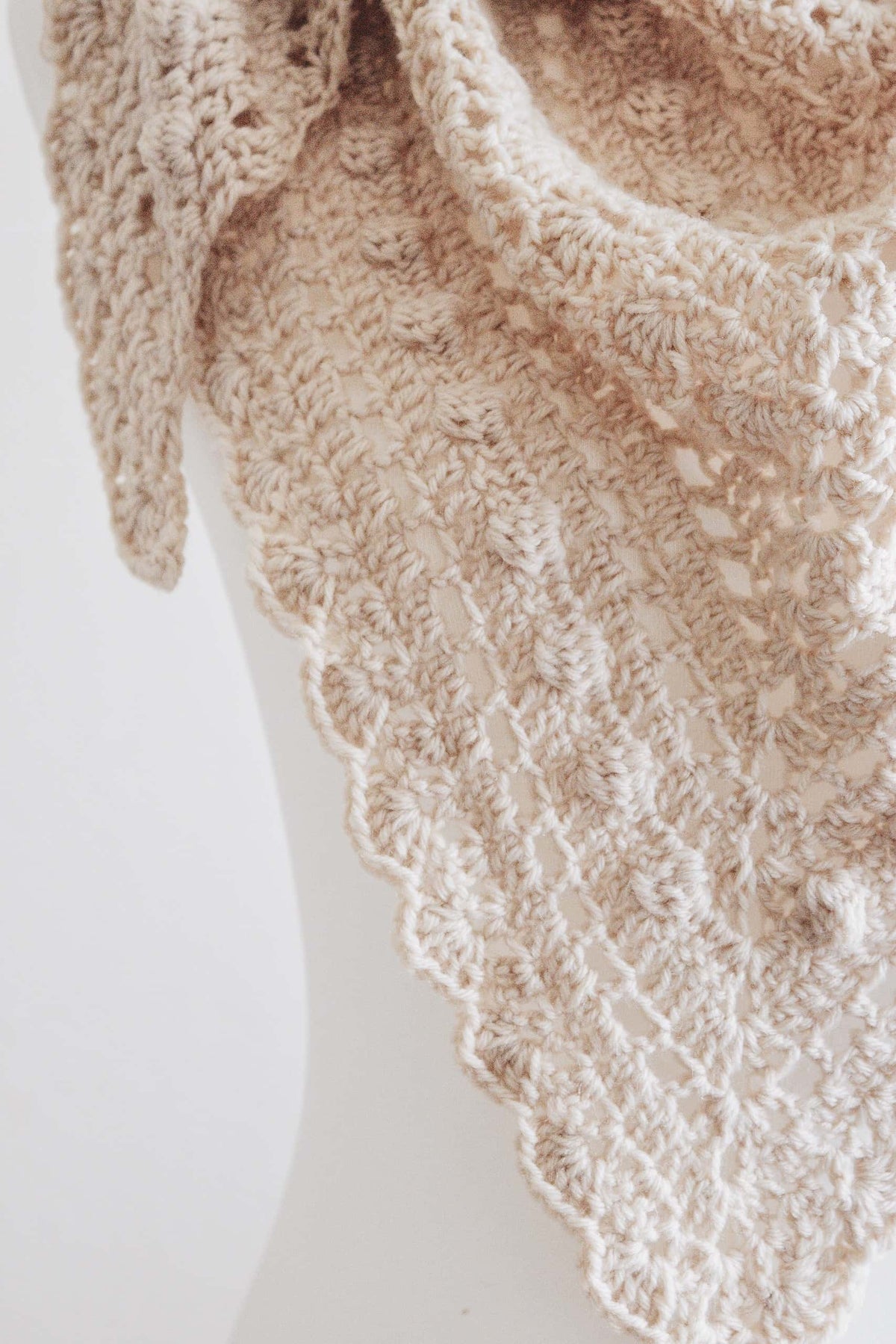Woman wearing elegant cream triangle shawl - Isla Scarf intermediate crochet pattern by Darling Jadore