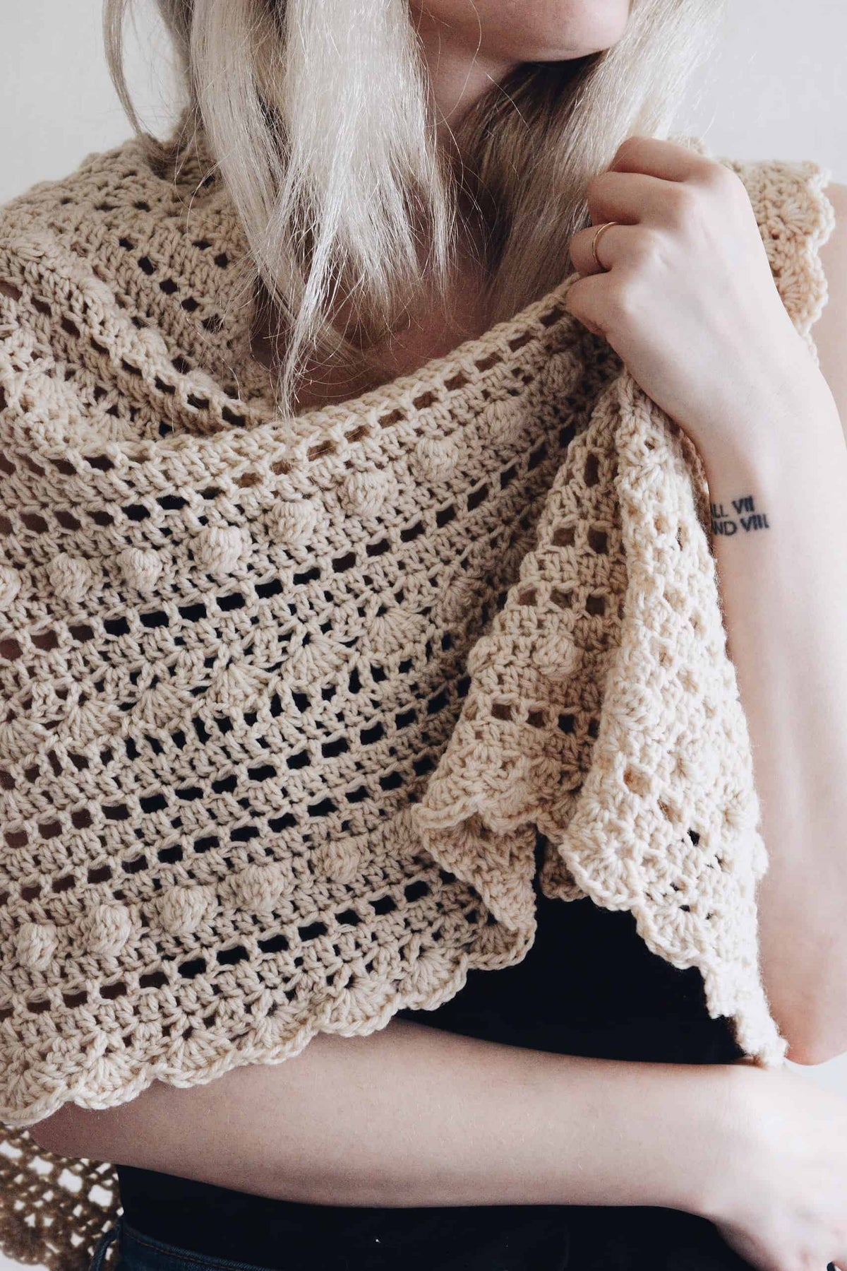 Detail of vintage-inspired lace crochet triangle scarf with delicate bobble stitch pattern