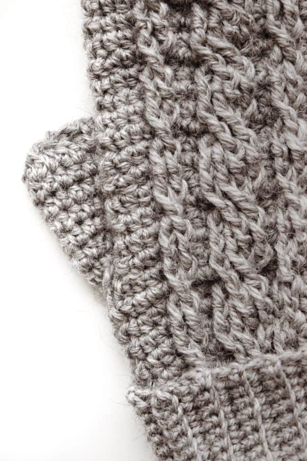 Close-up of cable stitch detail on Driftwood crochet mittens pattern in cream yarn