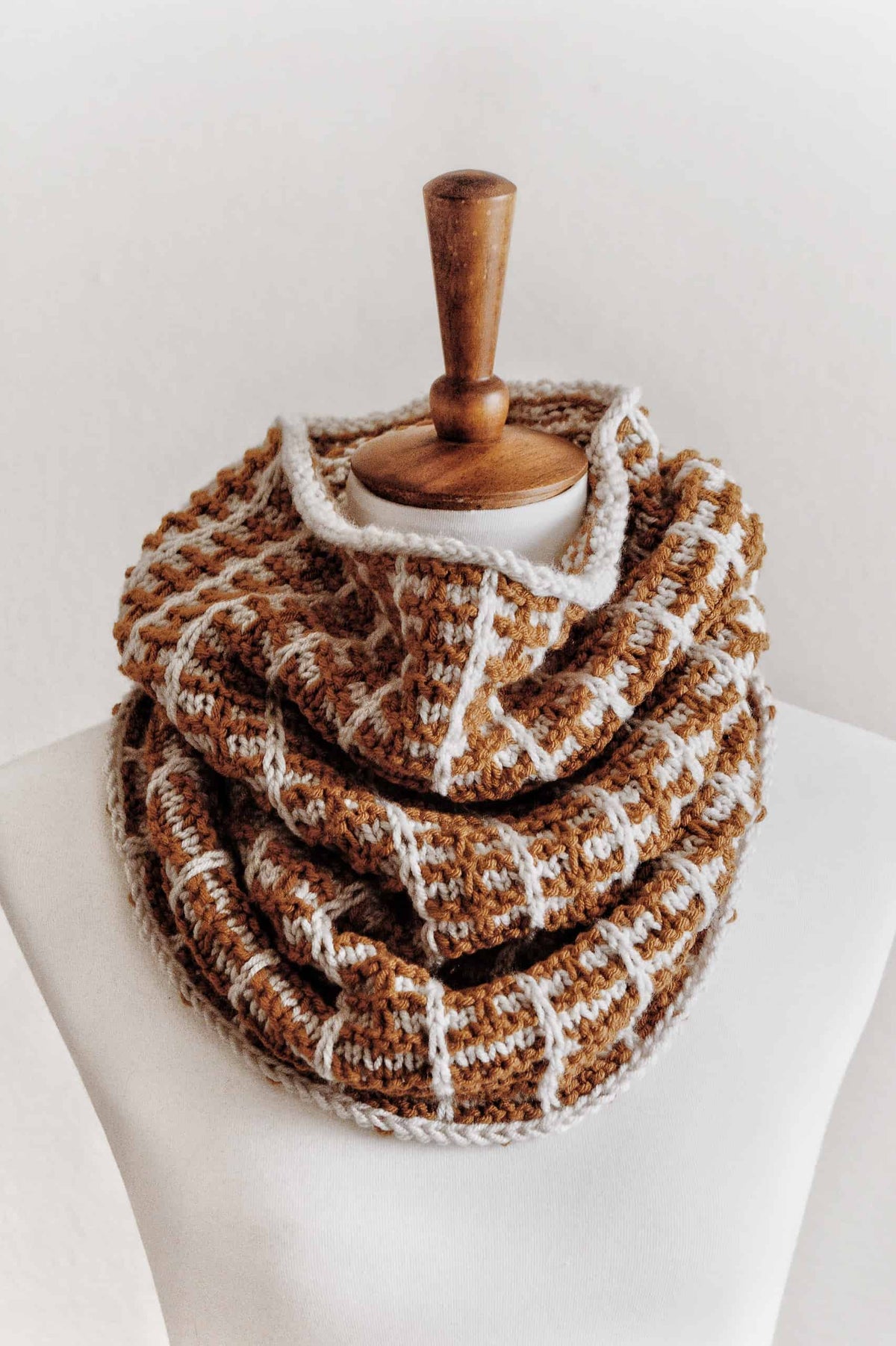 Side view of colorwork cowl knitting pattern draped around neck