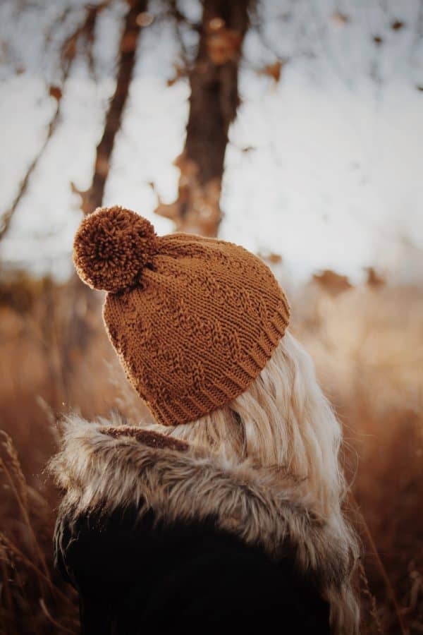 Close-up of faux cable stitch detail on Prairie Beanie knitting pattern in cream yarn