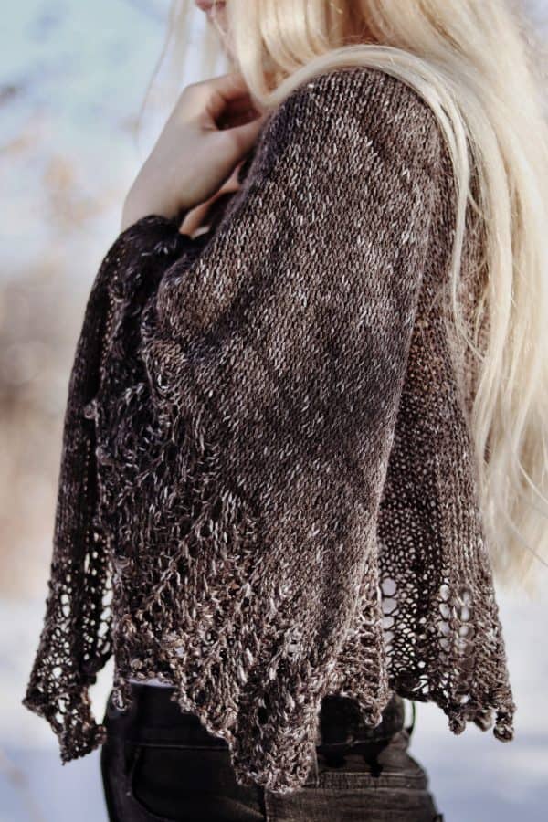 Cream knitted lace shawl draped over shoulders showing delicate stitch detail - Moonlit Shawl pattern by Darling Jadore