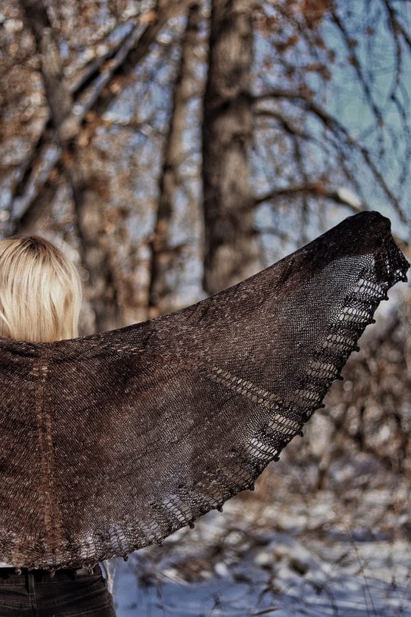 Black lace shawl knitting pattern showing intricate stitch detail and texture