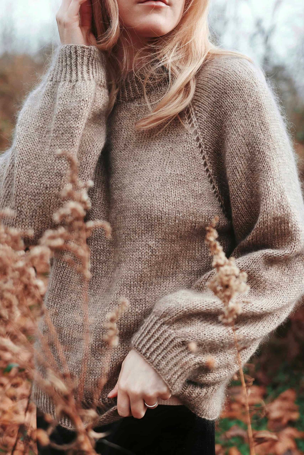 Woman wearing handknit Café Sweater in cream mohair with eyelet lace raglan details