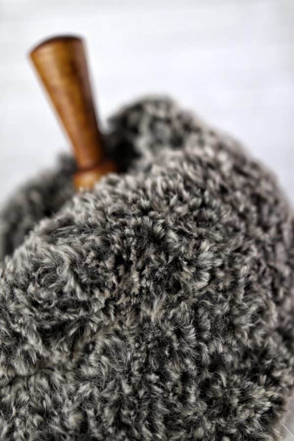 Cozy faux fur cowl scarf knitting pattern worn outdoors in snowy winter landscape