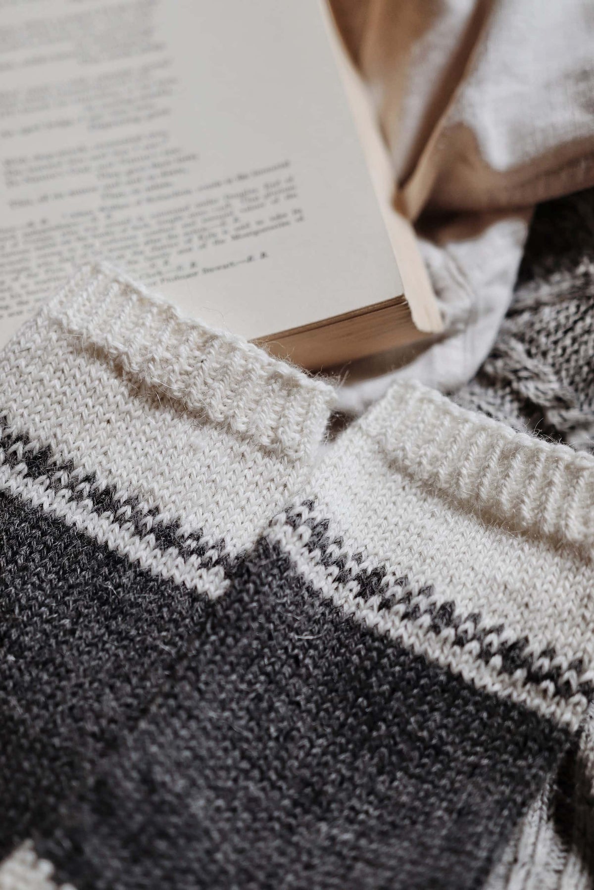 Detail of August Socks knitting pattern showing elegant Fair Isle band and ribbed cuff