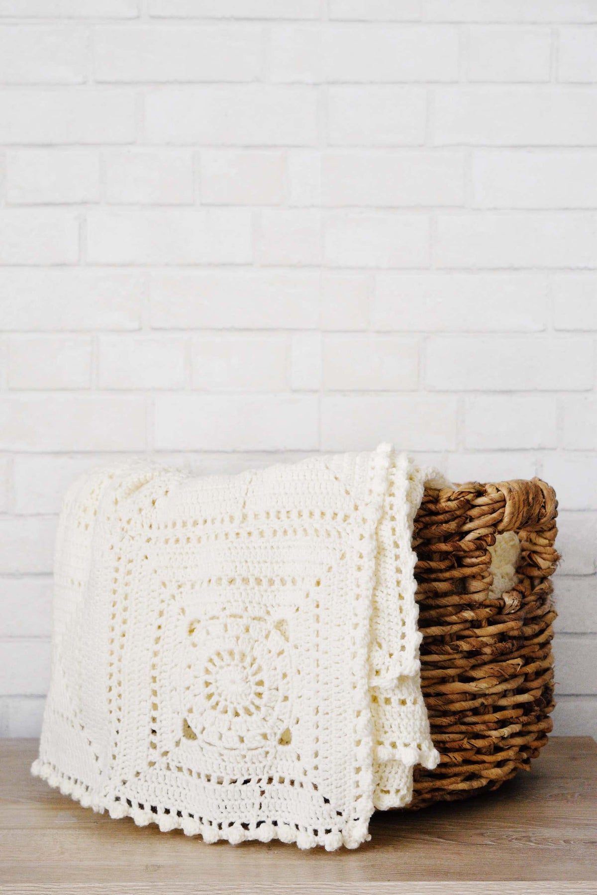 Finished Honeymilk crochet blanket styled in home setting showing full throw dimensions