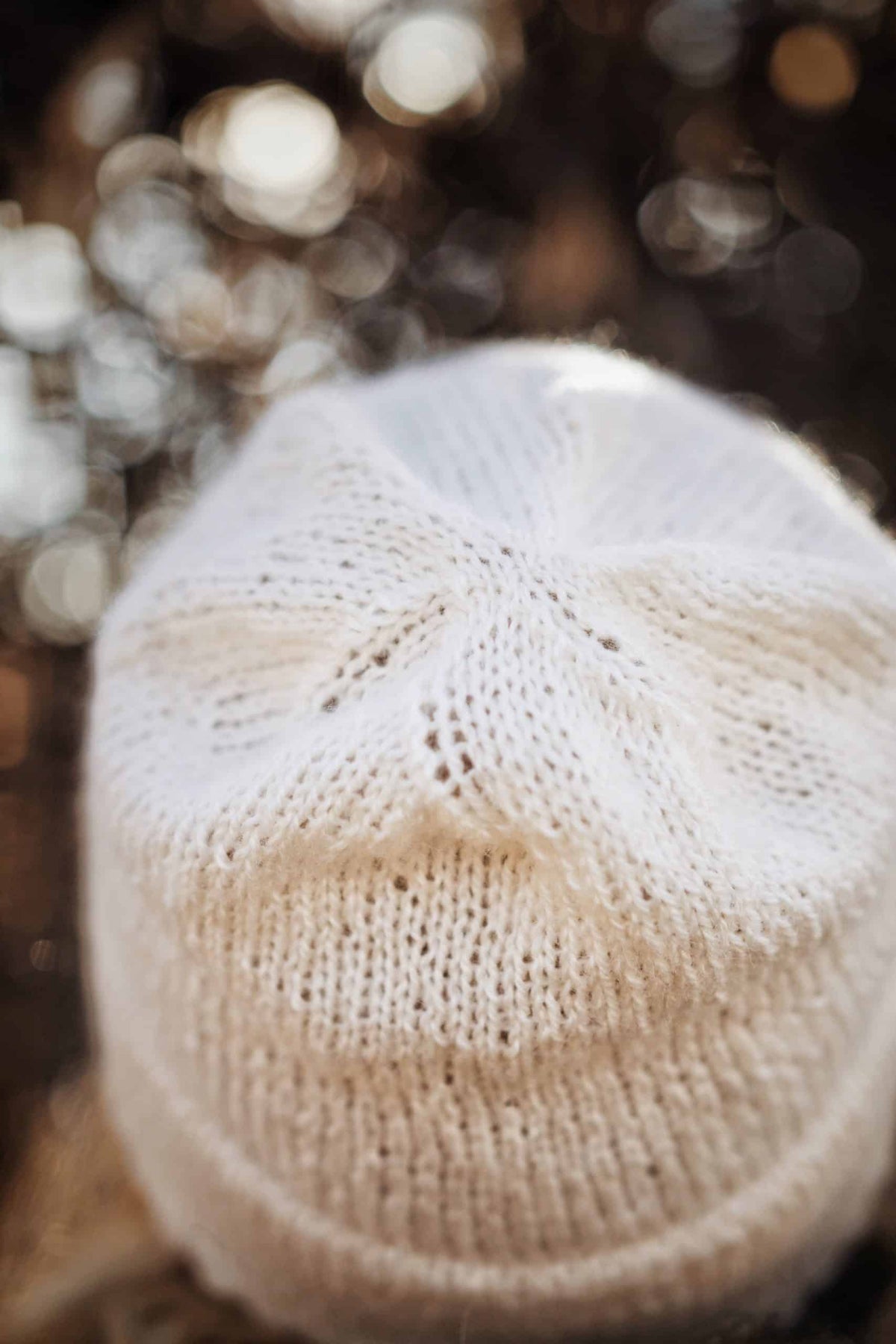 Woman wearing cream double brim beanie knit pattern with elegant picot edge