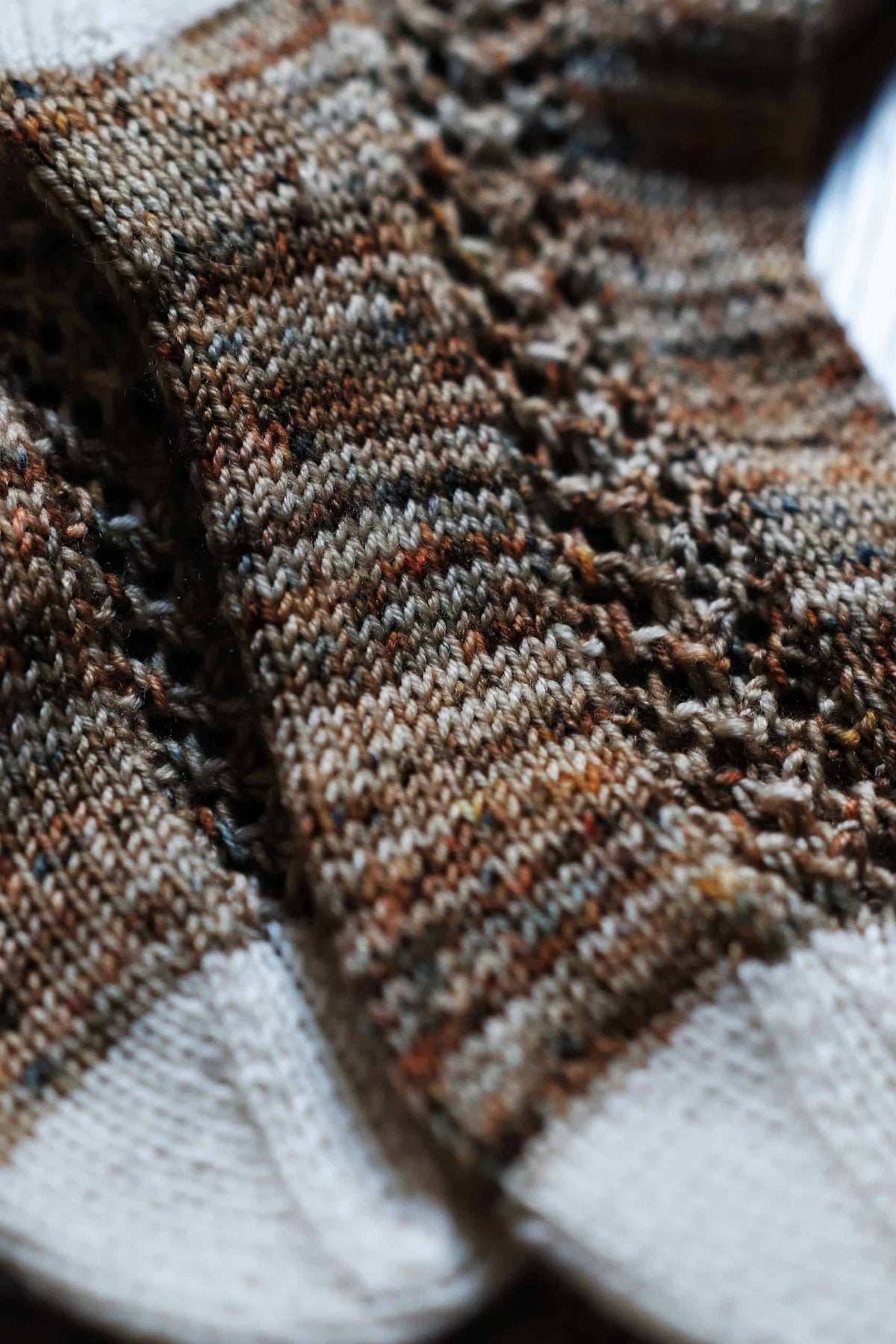 Side view of lace stripe socks in green yarn - The Garden Socks knitting pattern