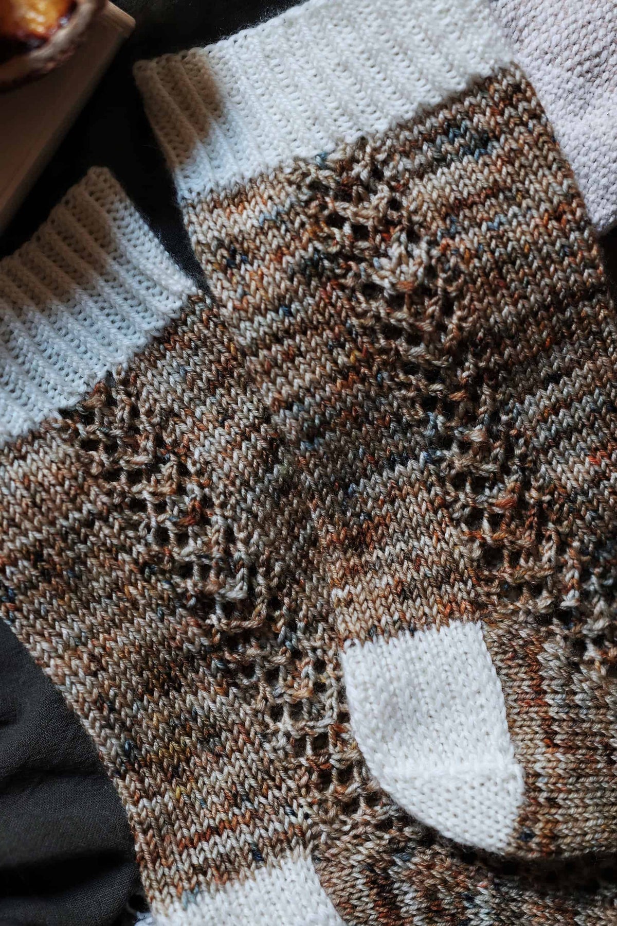 Close up of cascading lace panel on green knitted socks - The Garden Socks pattern detail