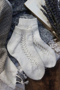 Gardenia lace socks knitting pattern showing elegant cascading lace panel detail on ankle