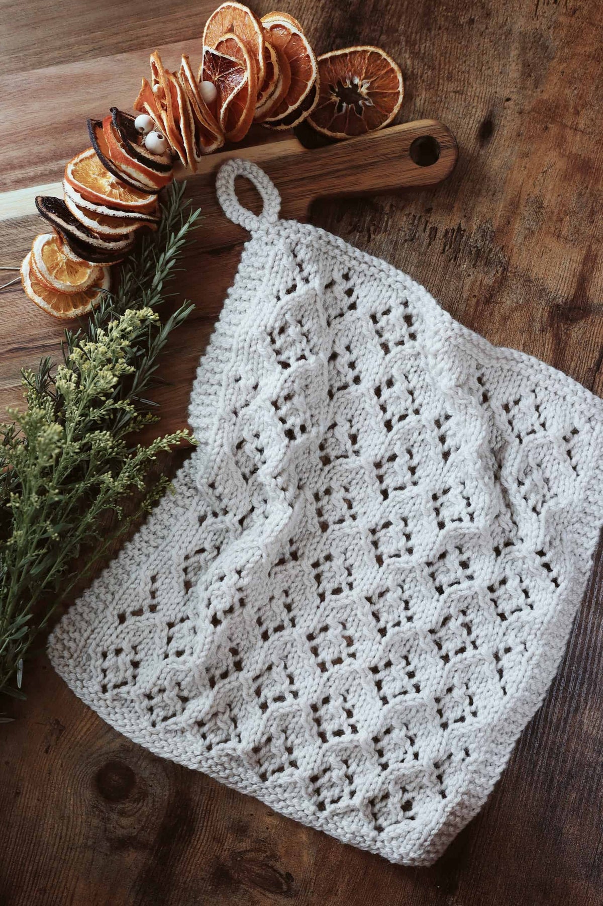 Knitted lace kitchen towel with geometric eyelet design in natural light