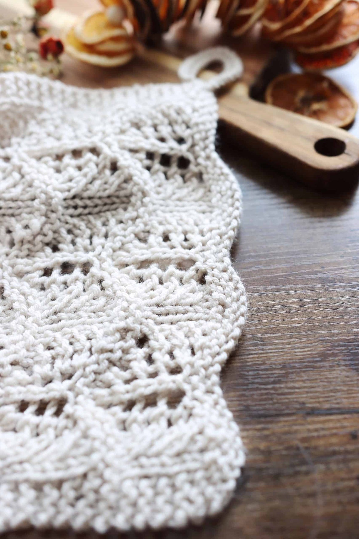 Modern tea towel knitting pattern with cascading lace waves and textured stripes