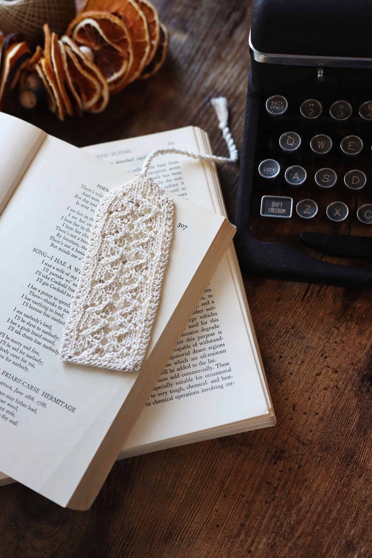 Handmade lace bookmark knitting pattern displayed with classic book