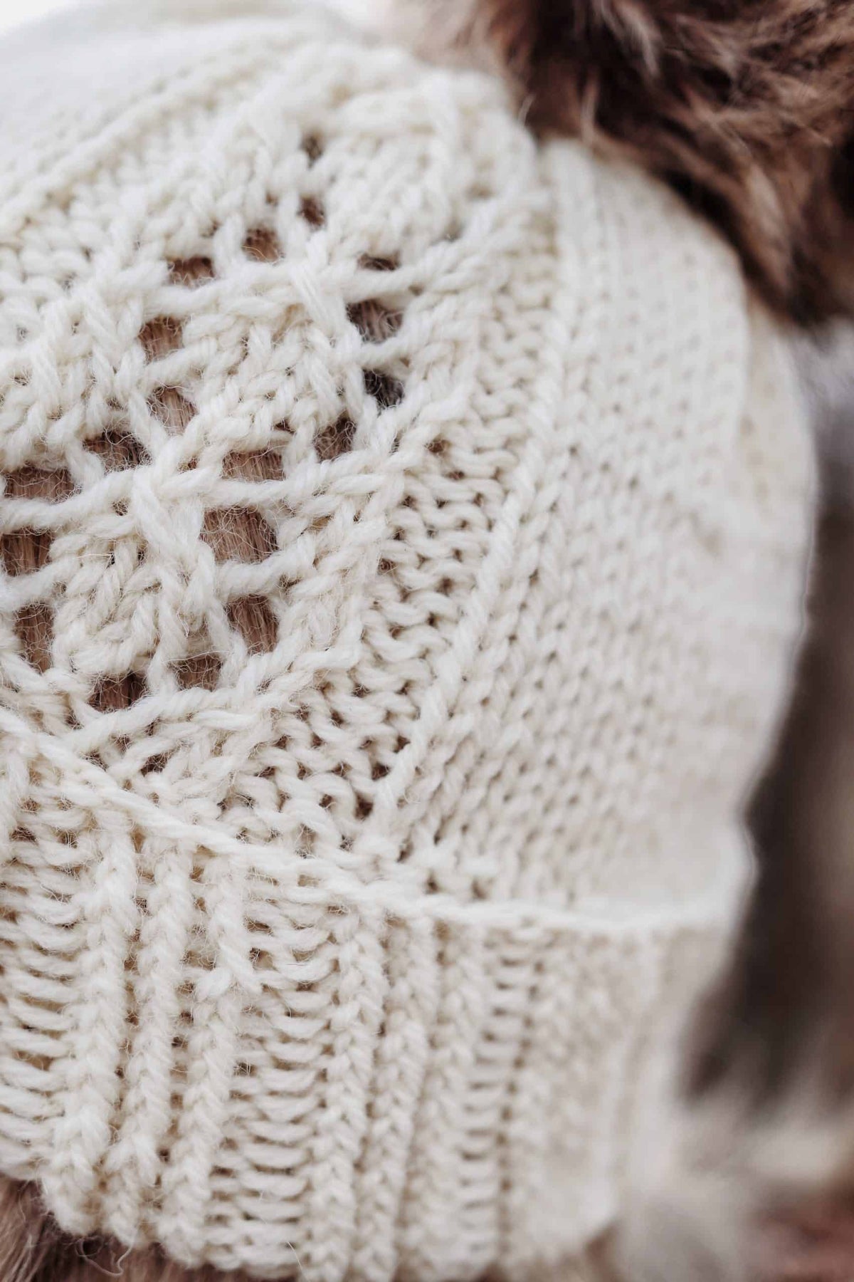 Close up detail of Phlox beanie showing ethereal lace pattern emerging from stockinette knit fabric