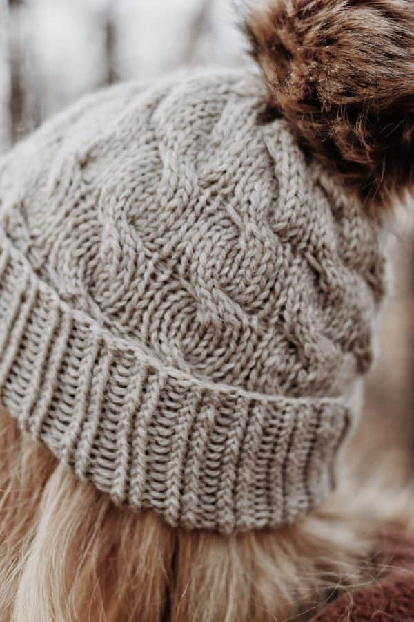 Close-up of cable knit beanie pattern showing flowing cable texture detail