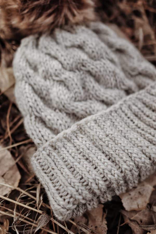 Side view of Cedar cable beanie knitting pattern with ribbed fold-up brim