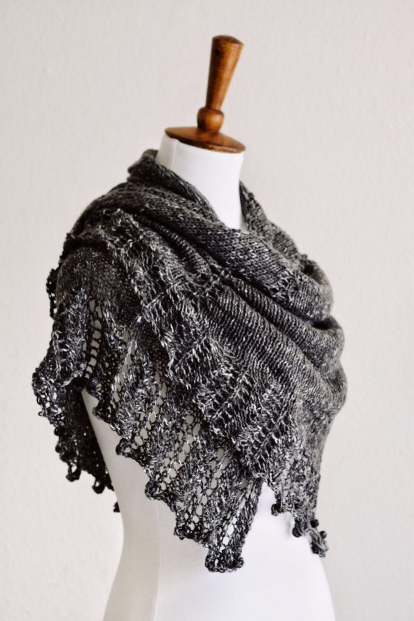 The Moonlit Shawl lace knitting pattern with dramatic spiked edging draped elegantly