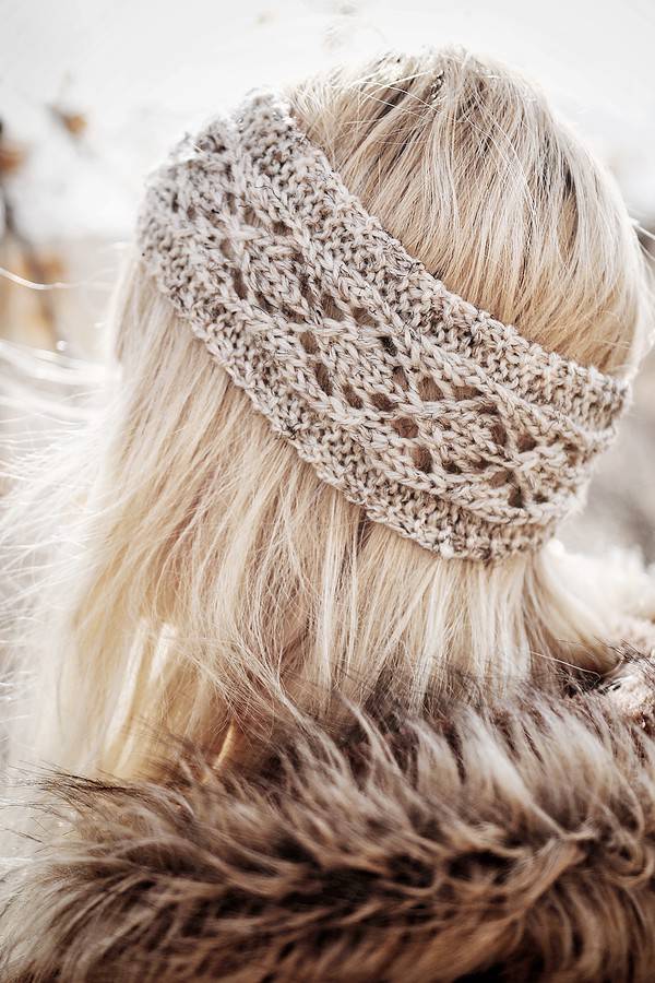 Phlox lace headband knitting pattern with delicate floral lacework detail on model