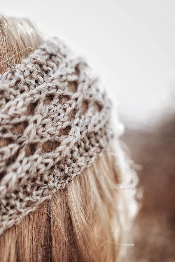 Back view of lace earwarmer headband knitting pattern showing elegant construction