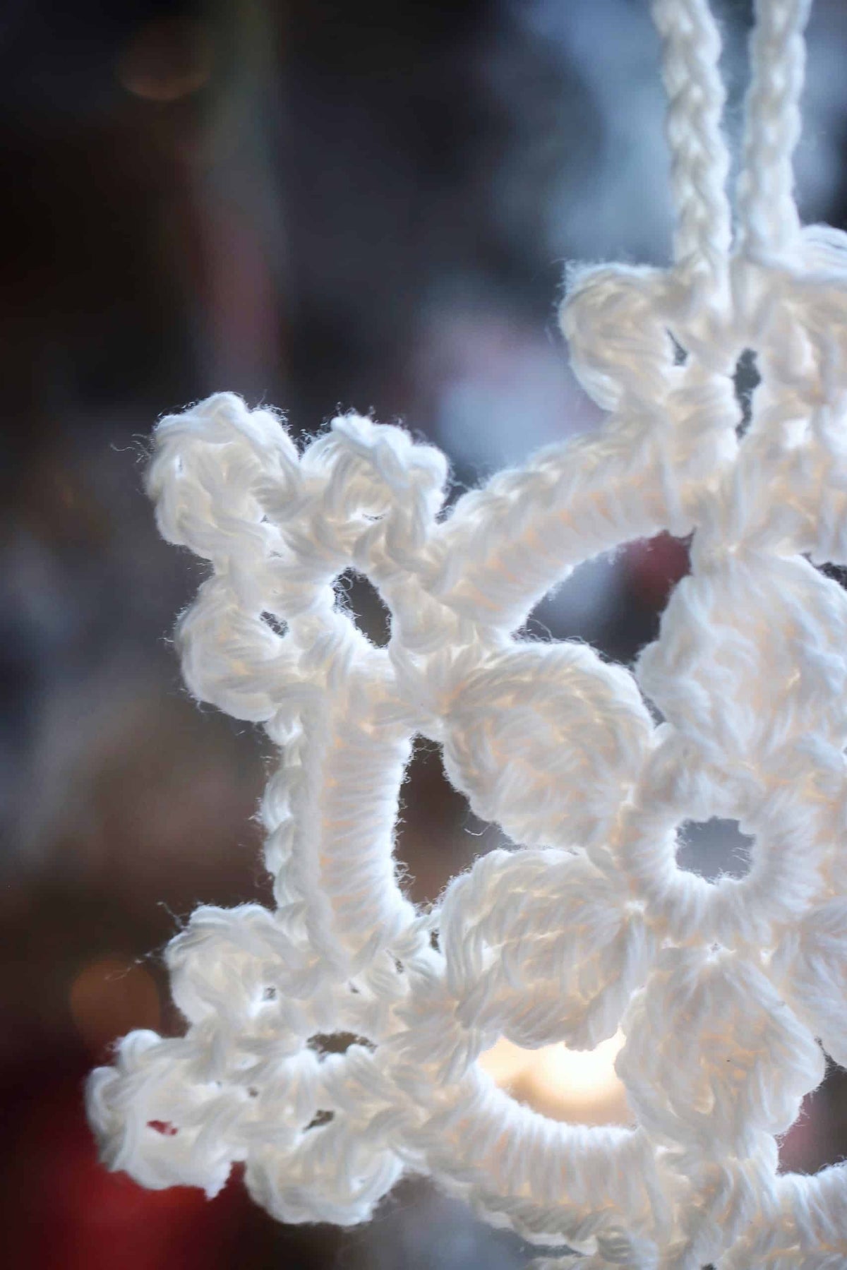 Vintage-inspired crochet snowflake ornament close-up showing cluster stitch texture