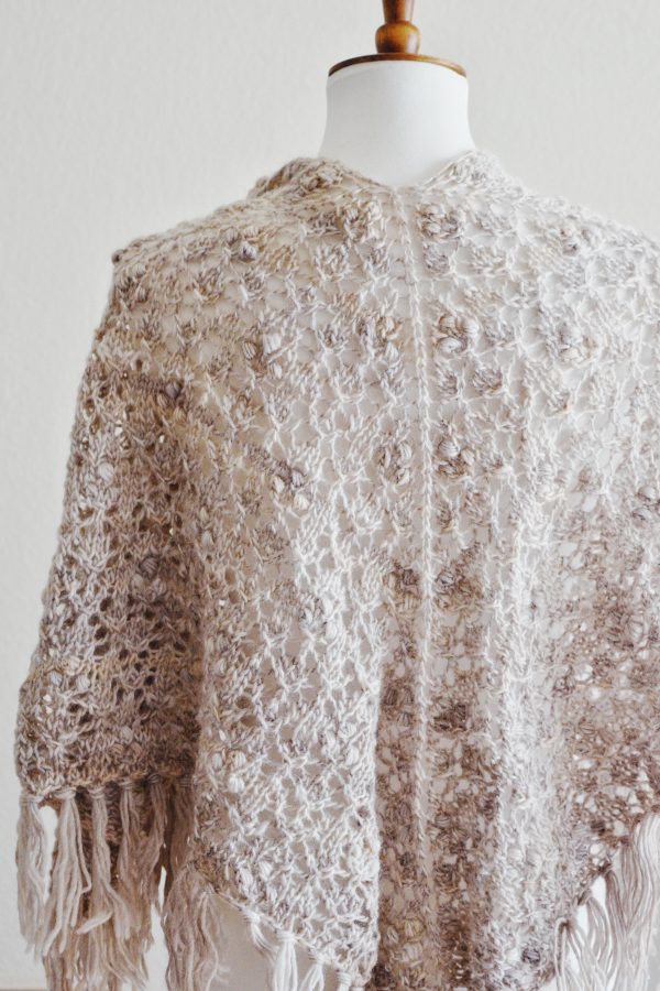 Boho-style Calyx shawl with textured lace and tassel fringe