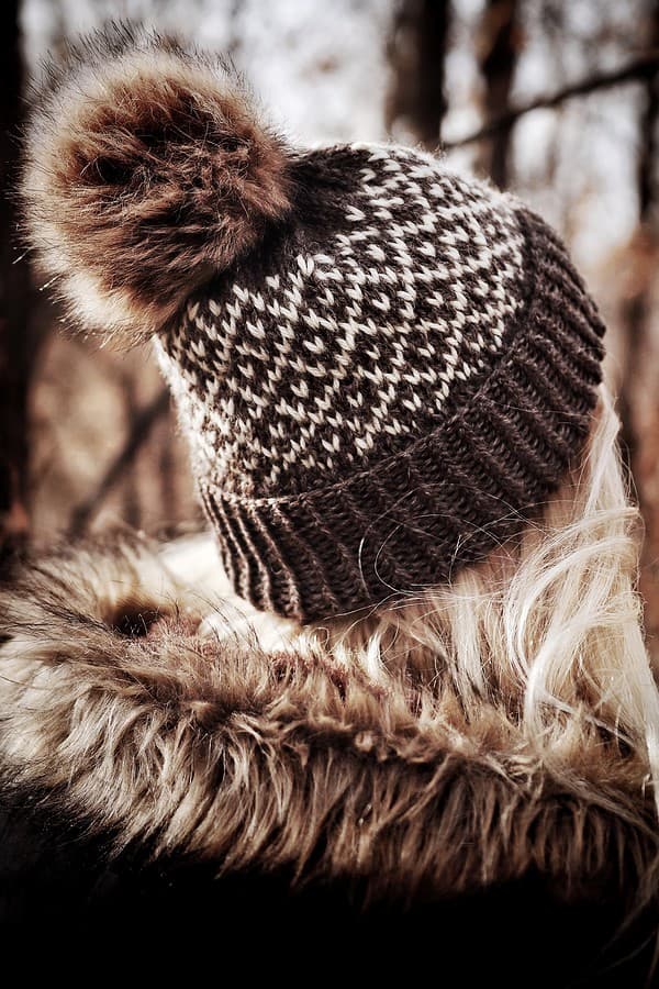 Woman wearing handknit Dewdrop fair isle beanie with fold-over brim