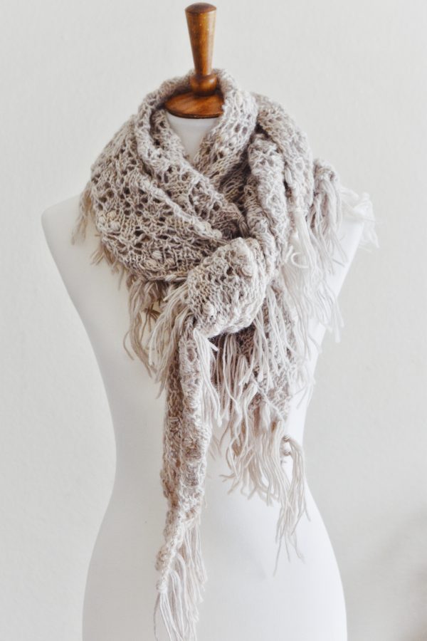 Woman wearing handknit Calyx lace shawl draped over shoulders