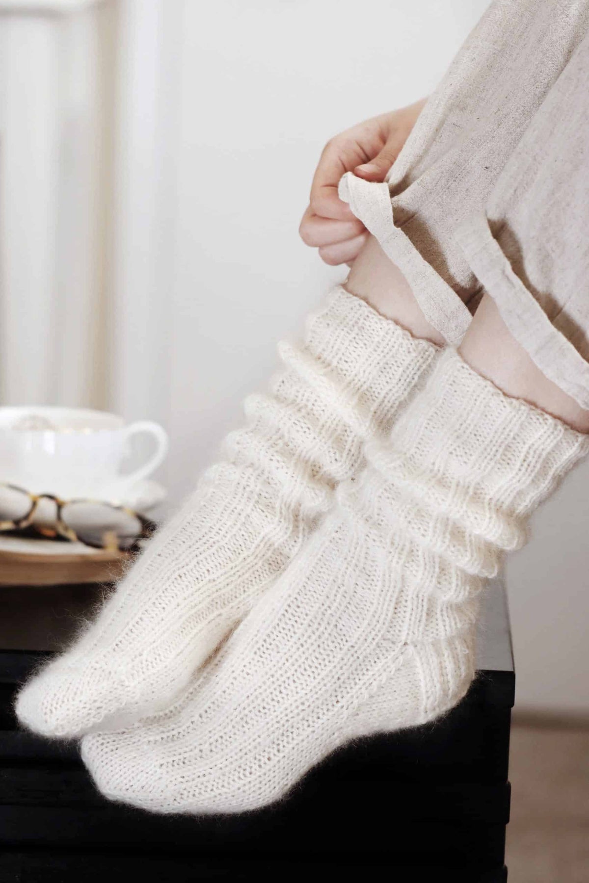 Cream ribbed knit socks worn with cozy sweater - beginner socks knitting pattern by Darling Jadore