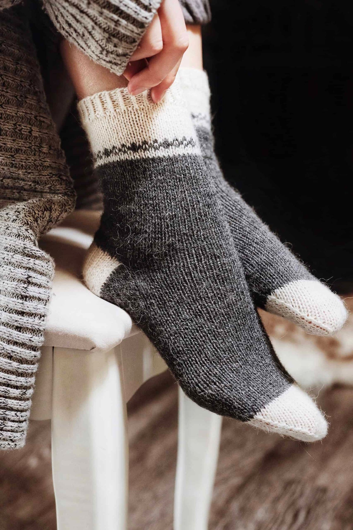 Flat lay of August Socks knitting pattern showing classic boot sock construction