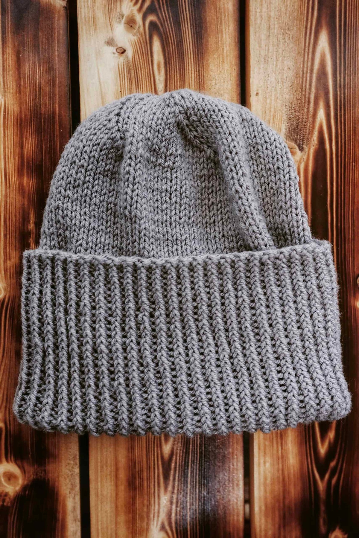 Hand knit men's beanie pattern close up showing ribbed texture and fit