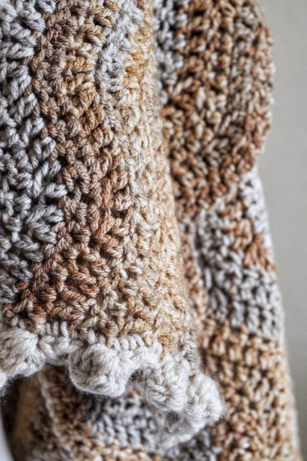 The Riverbed blanket scarf crochet pattern styled as warm winter wrap in neutral tones