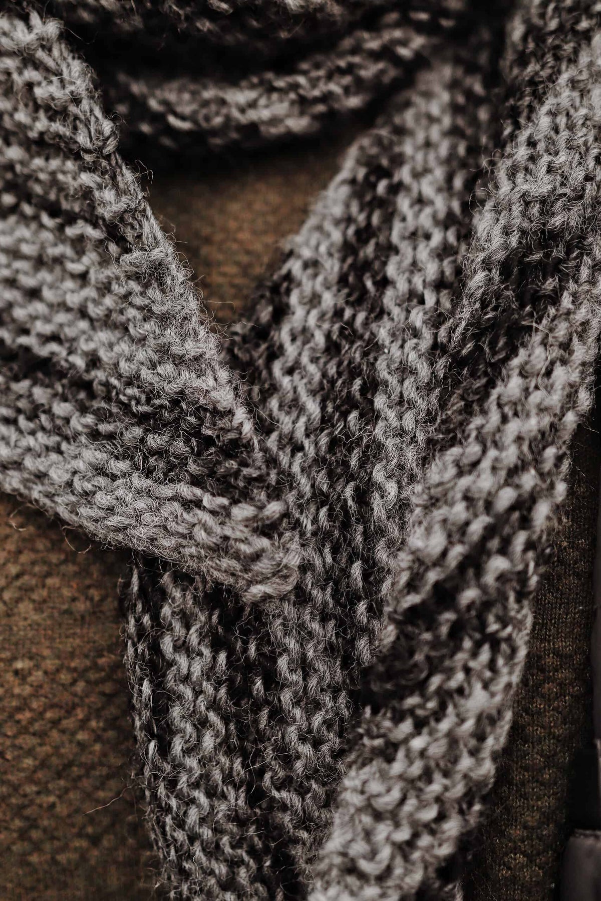 Man wearing The Altitude Scarf geometric bias knit pattern