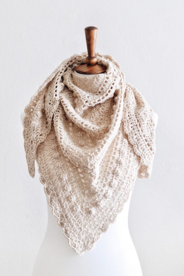 Woman wearing cream lace triangle scarf with bobble details - Isla Scarf crochet pattern by Darling Jadore