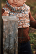 Cream colored knitted toddler dickey neck warmer flat lay on white background