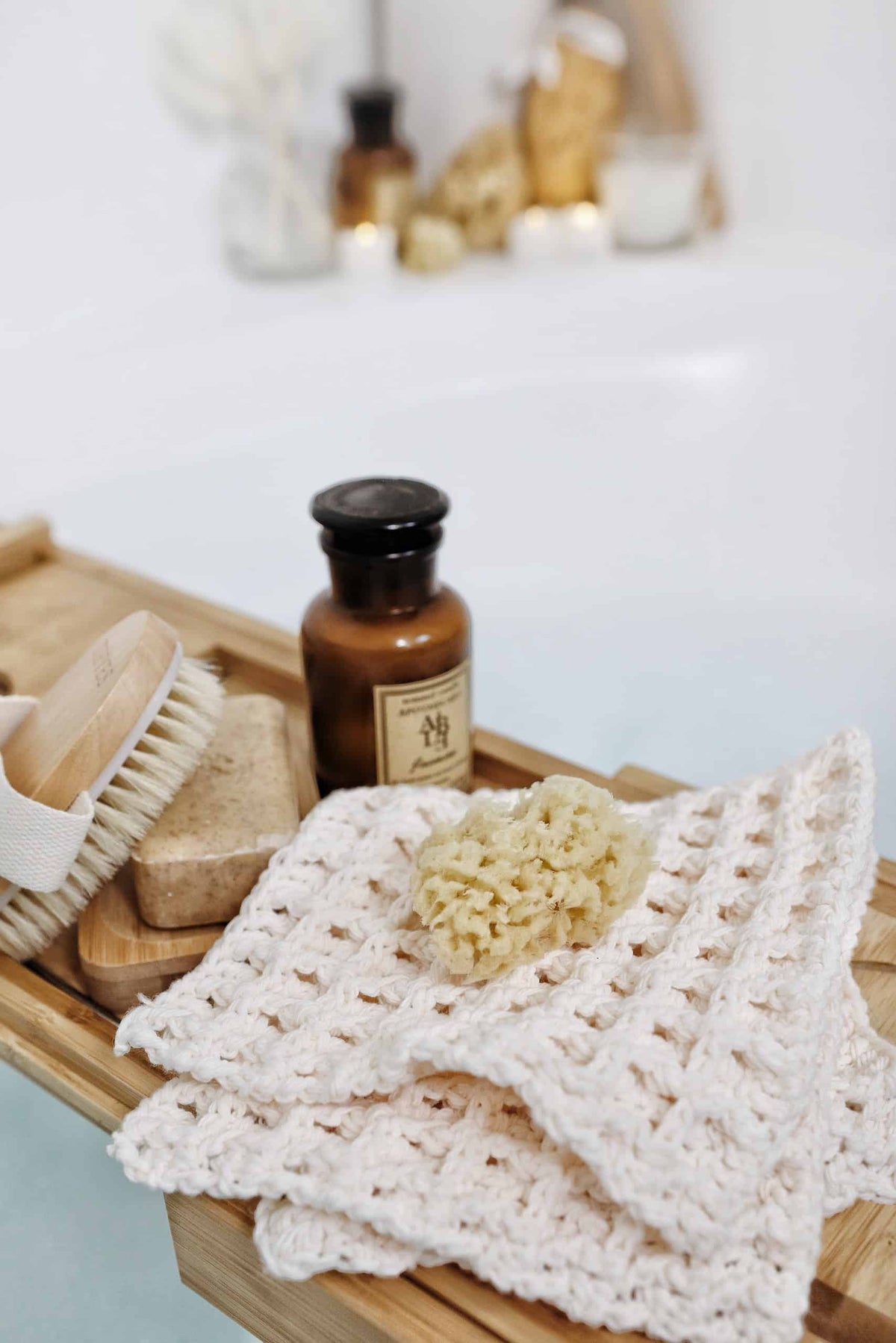 Textured crochet wash cloths in white cotton yarn with waffle stitch pattern on rustic wooden surface