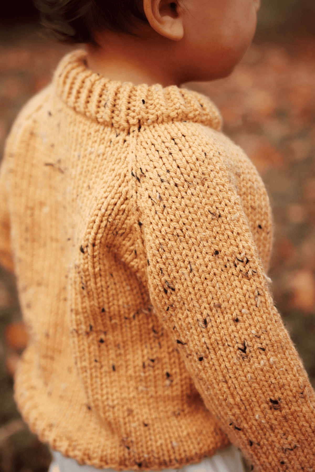 Toddler sweater knitting pattern detail showing durable double-knit neck and raglan sleeve construction