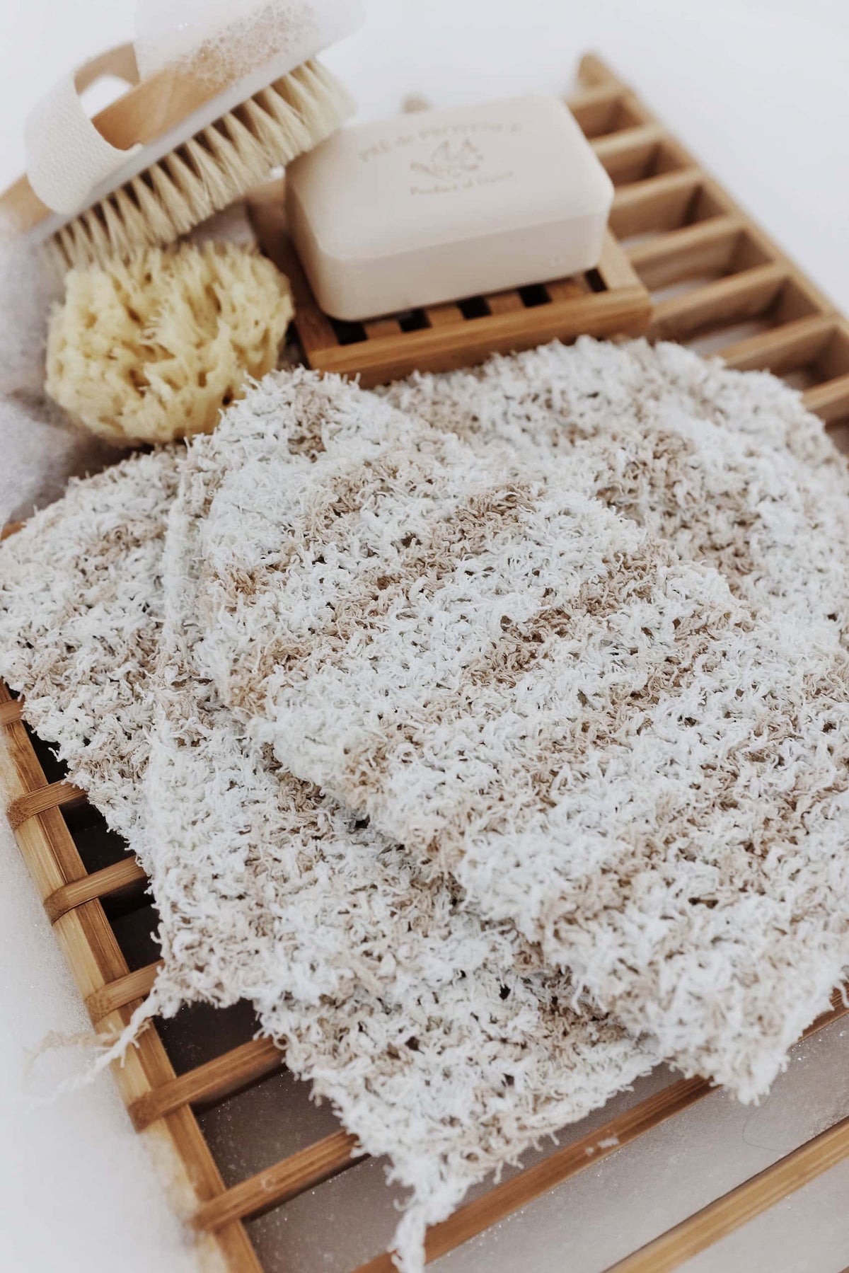 Close-up of knitted exfoliating wash cloth showing soft scrubby pebble texture detail