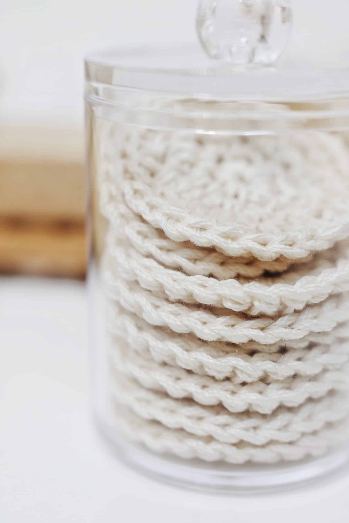 Close-up of crocheted reusable cotton rounds showing soft nubby texture for gentle makeup removal