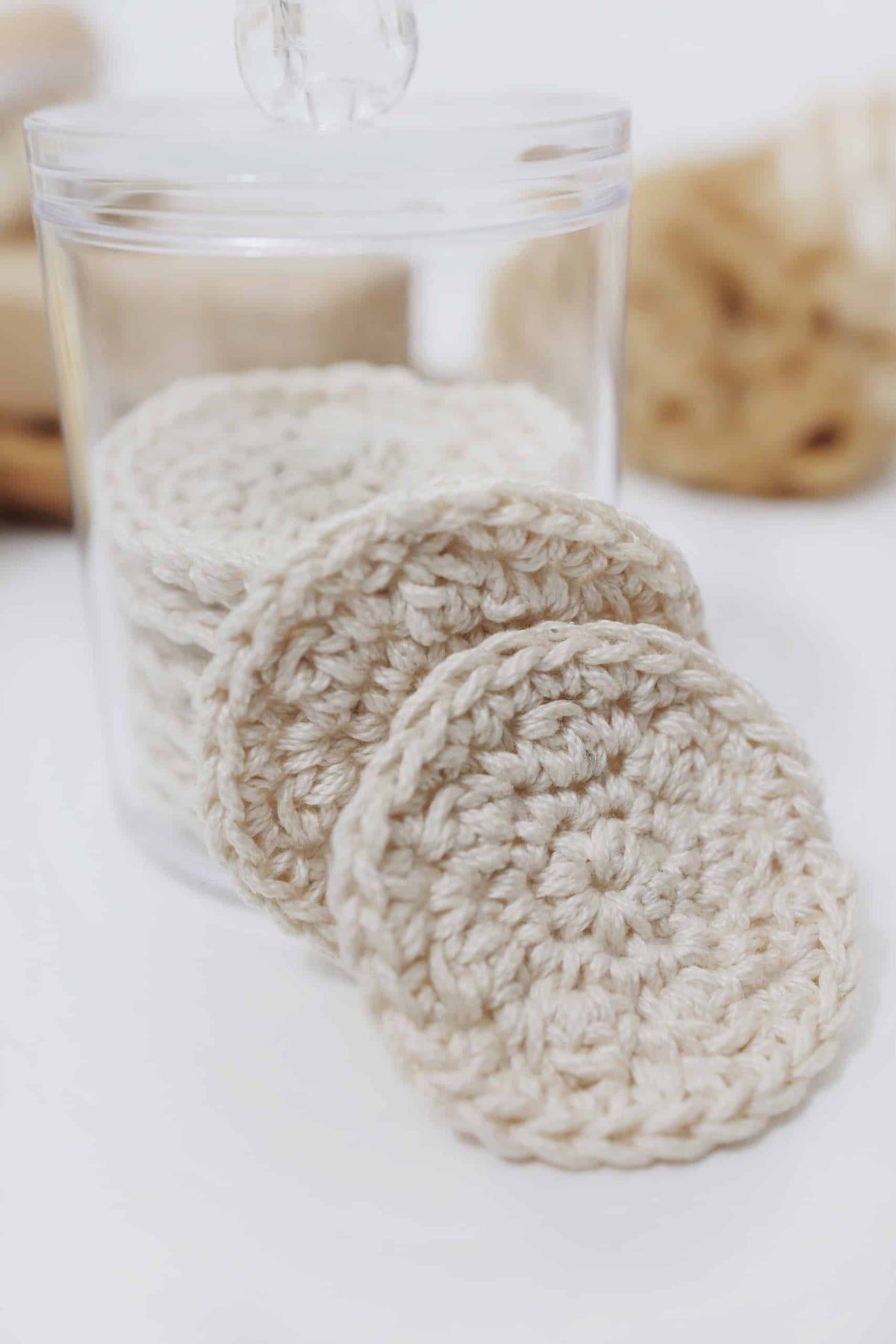 Eco-friendly reusable cotton rounds crochet pattern displayed with skincare products