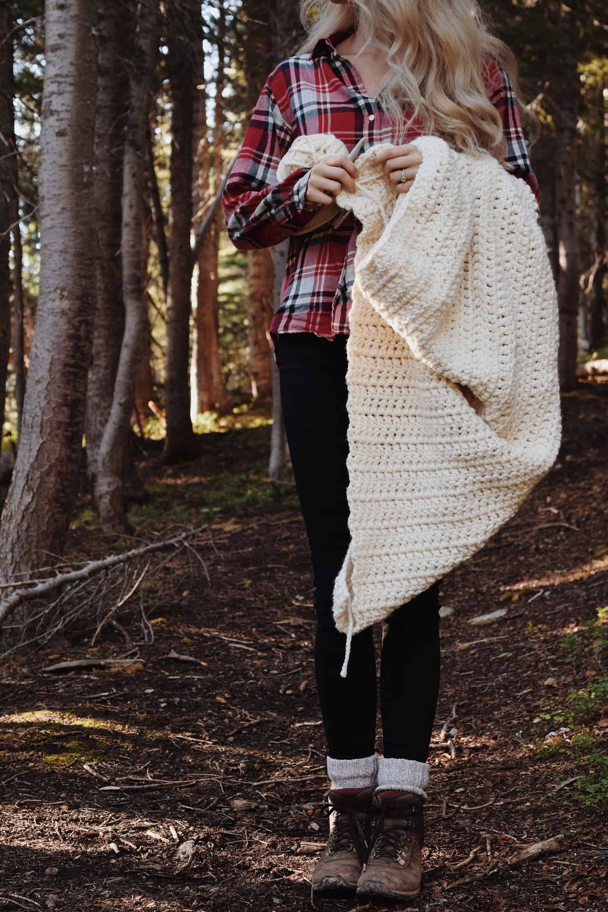 Cozy hygge home decor with The Chateaux crochet throw blanket in neutral living room setting