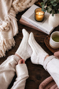 Cream knit ankle socks on a cozy blanket - The Ankle Chalet Socks Knitting Pattern by Darling Jadore