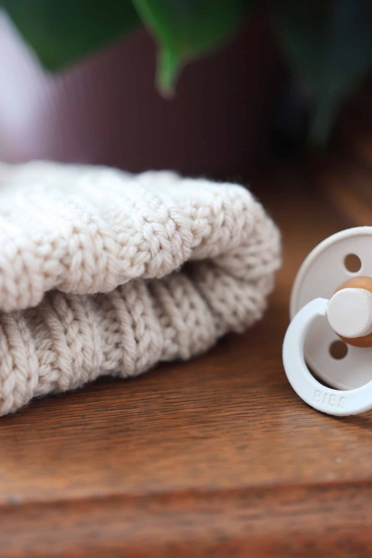 Classic fold-up baby beanie knitting pattern in cream yarn