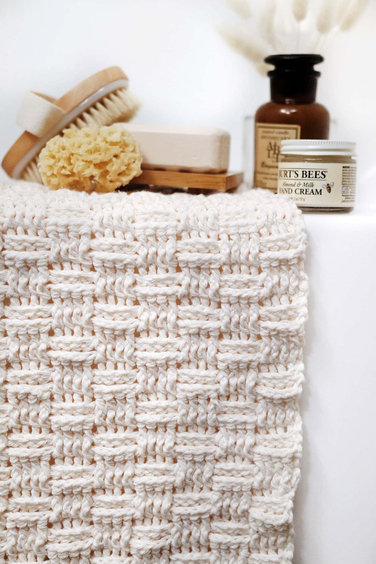 Eco-friendly crocheted bath mat with soft woven design in minimalist bathroom