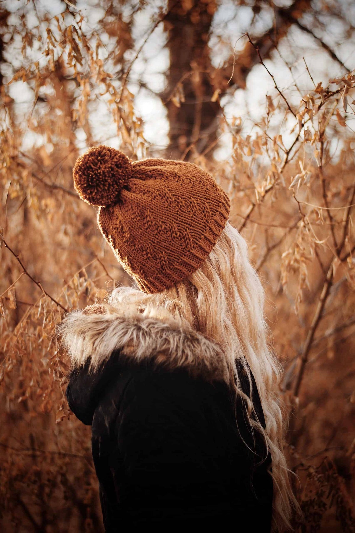 The Prairie Beanie knitting pattern with faux cable texture in cream yarn on wooden background