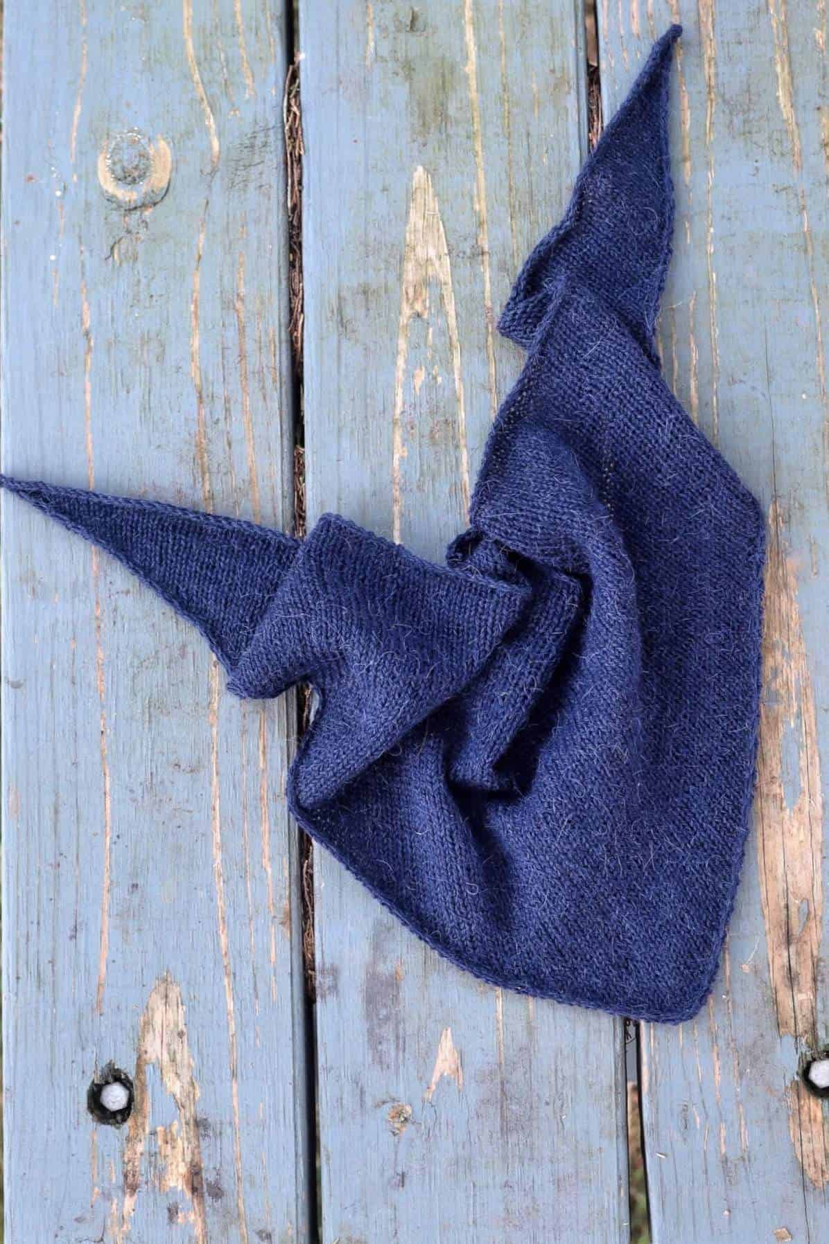 Small triangle scarf knitting pattern worn as neck kerchief showing timeless style